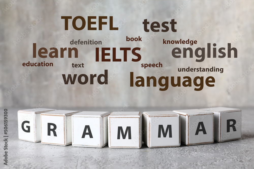 Text GRAMMAR made of cubes and different words on light background. Concept of studying English